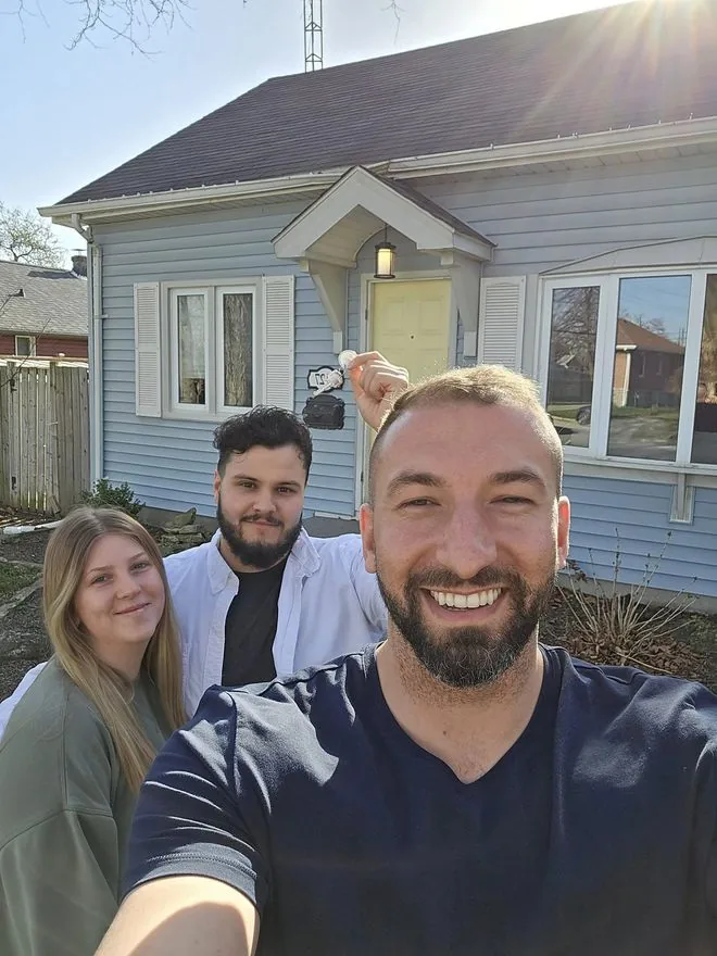 Daniel Zanettin handing over keys to happy new homeowners in Windsor